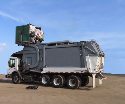 Front view of a skip in an urban Hoxton street, illustrating skip hire services.