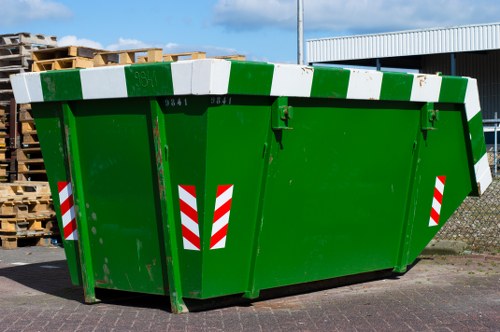 Builder placing a skip on a construction site in Hoxton