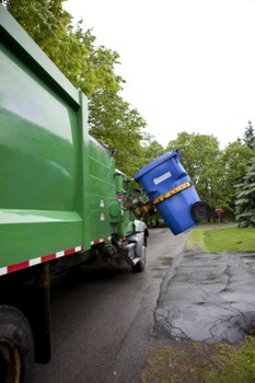 Team wearing PPE and loading a skip safely